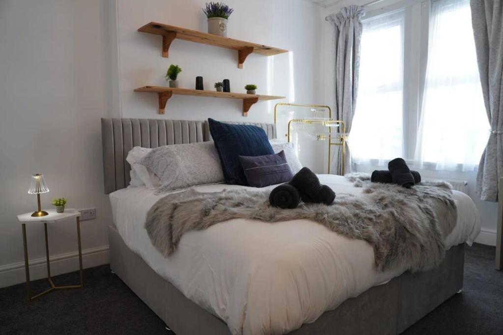a bedroom with a bed with two black stuffed animals on it at Modern spacious 6 bed in Central Plymouth with Parking in Plymouth