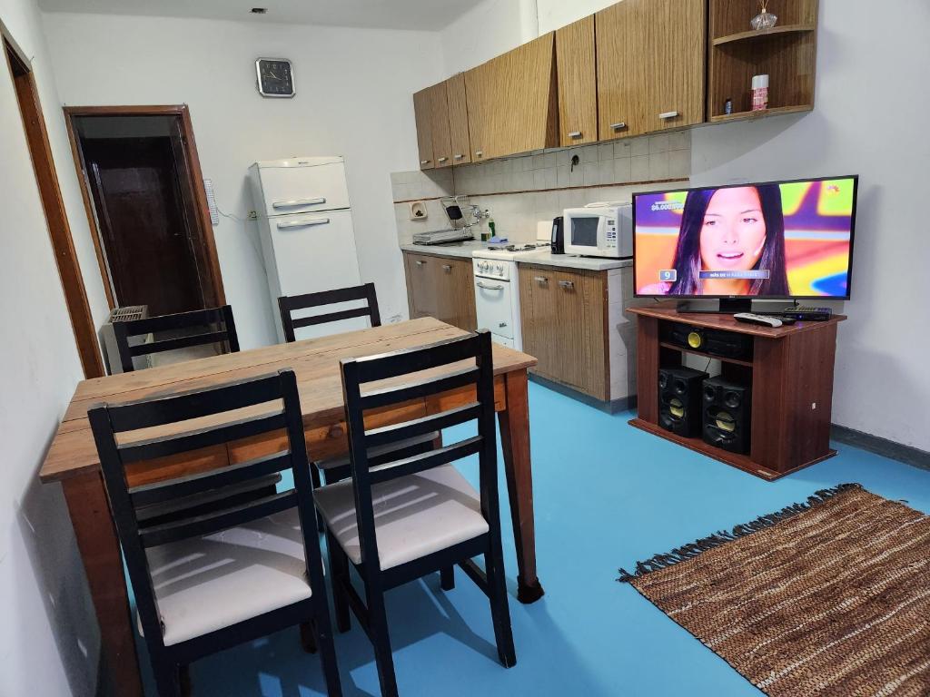a kitchen with a dining table and a television at LUNA in Comodoro Rivadavia