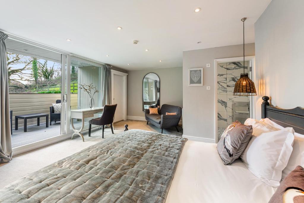 a bedroom with a large bed and a living room at The Bickley Mill in Newton Abbot