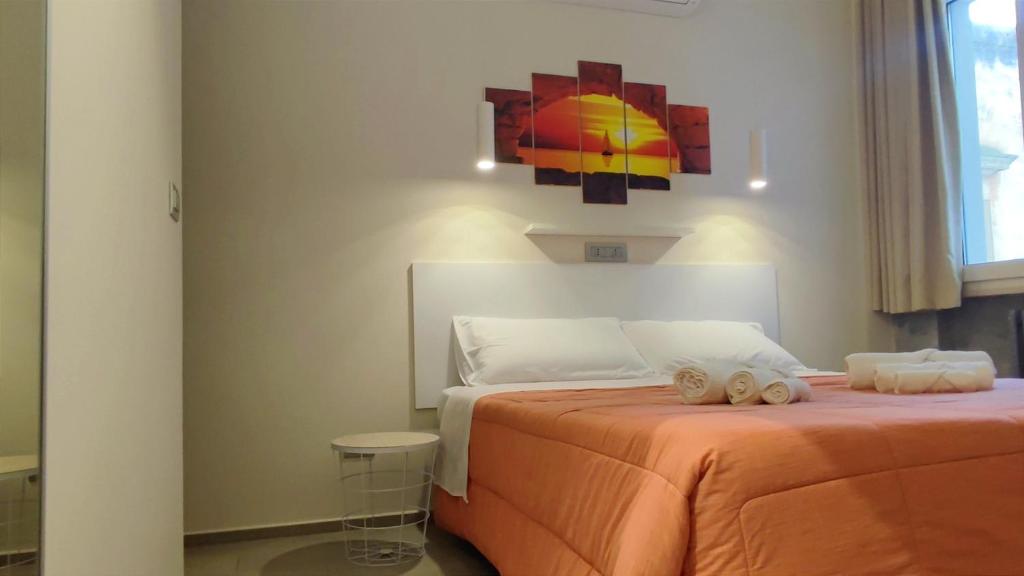 a bedroom with a bed with two towels on it at Baccaro's home B&B in Brindisi