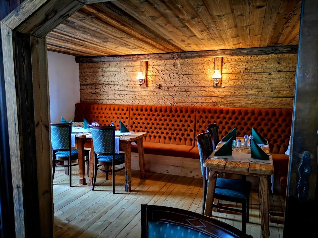 ein Esszimmer mit Tischen und Stühlen in einem Restaurant in der Unterkunft Gasthaus Auwirt in Fieberbrunn