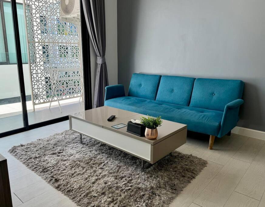 a living room with a blue couch and a coffee table at Utopia - the best condo project at Naiharn in Rawai Beach