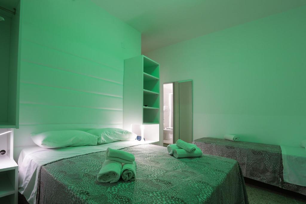 Postel nebo postele na pokoji v ubytování Hotel Ninfea Cattolica