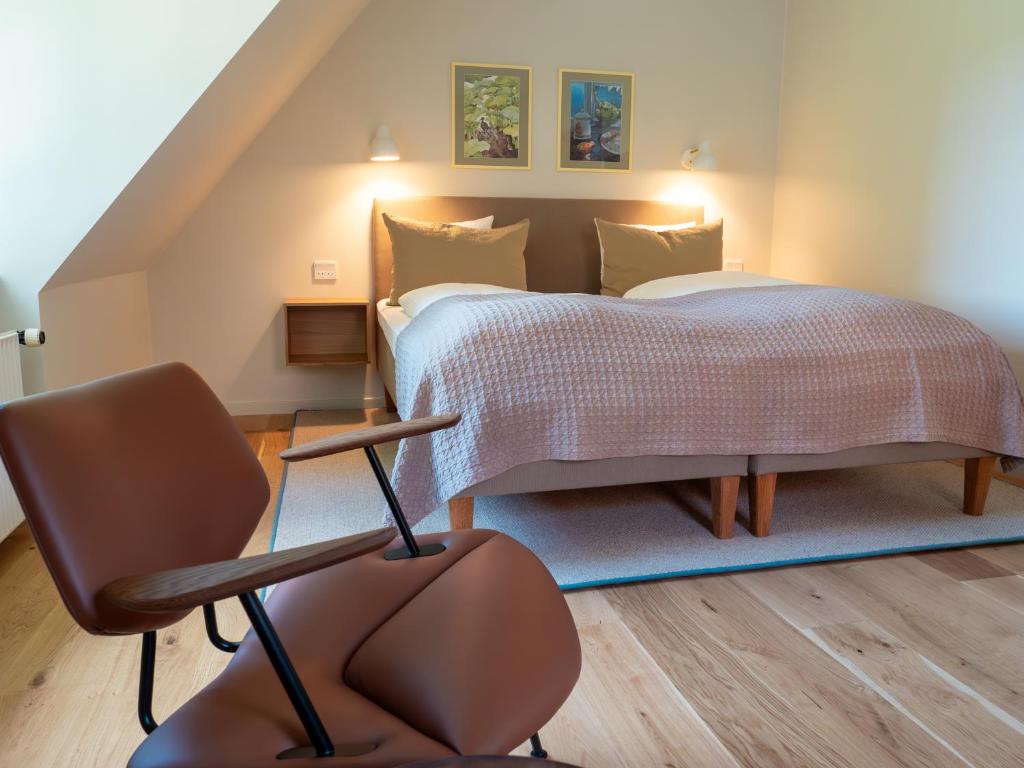 Postel nebo postele na pokoji v ubytování Hotel Knudsens Gaard