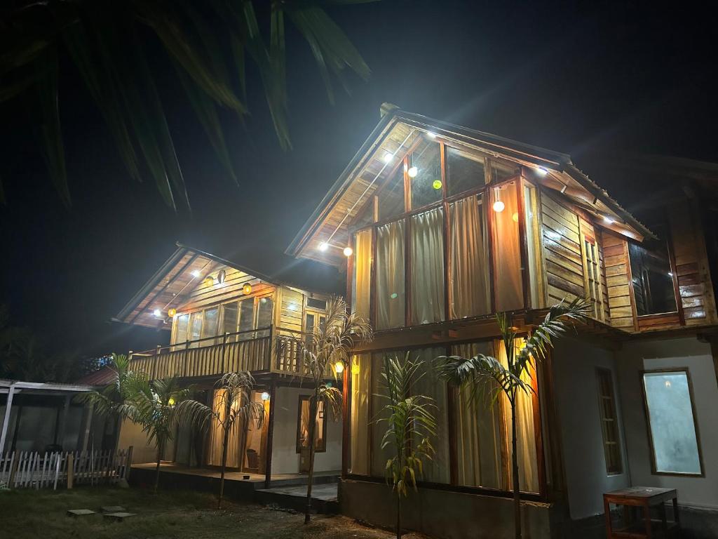 a house with lights on it at night at Blue Lagoon Villa in Pāsighāt