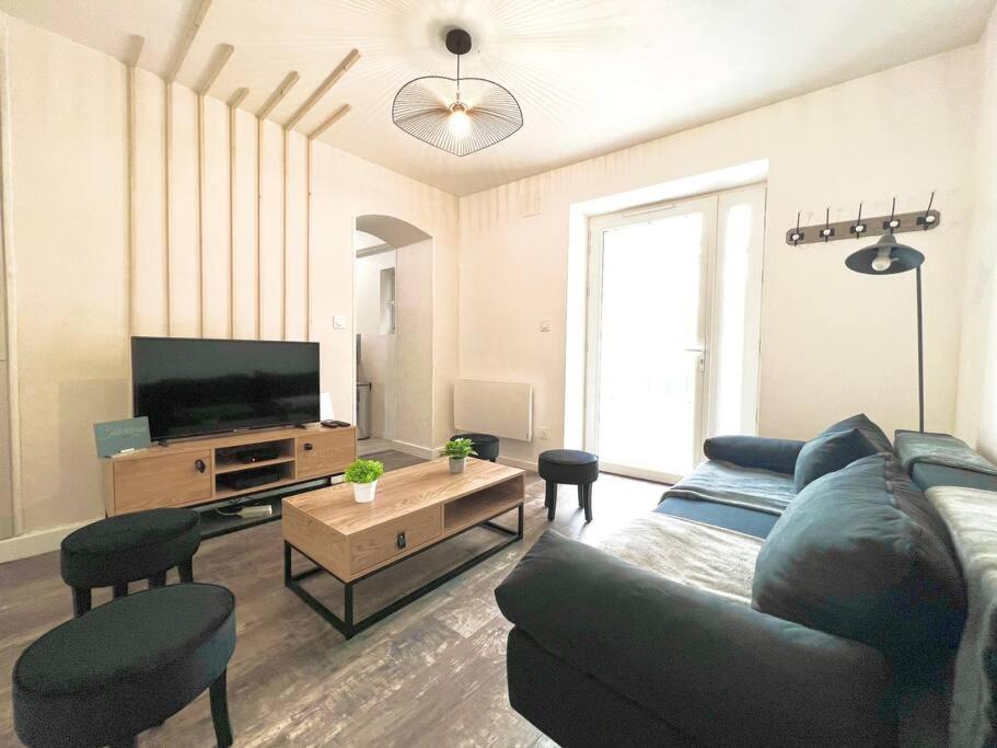 a living room with a couch and a flat screen tv at La baillargeoise - Superbe maison à 7 min du parc in Saint-Georges-lès-Baillargeaux