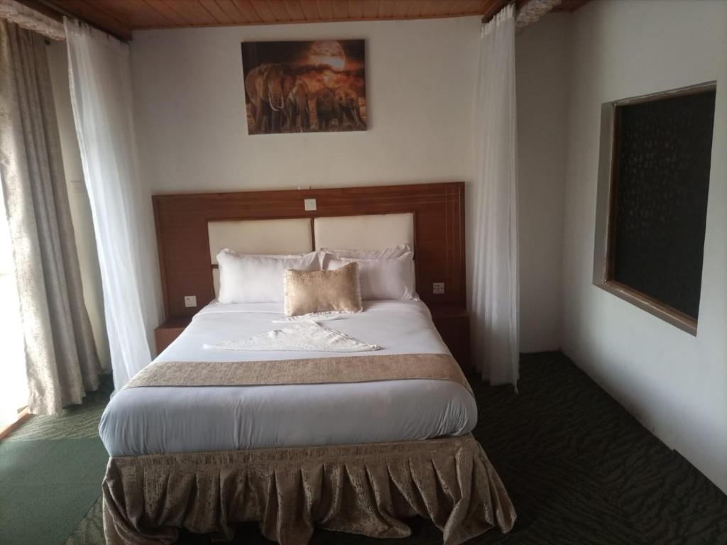 a bedroom with a large bed in a hotel room at Deep Sea Resort in Kitale