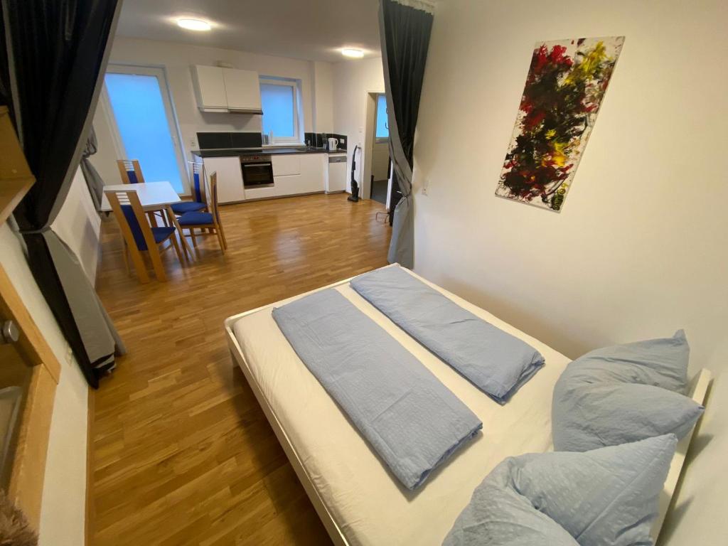 a room with two beds and a living room with a kitchen at Appartement Emat 13 in Telfs
