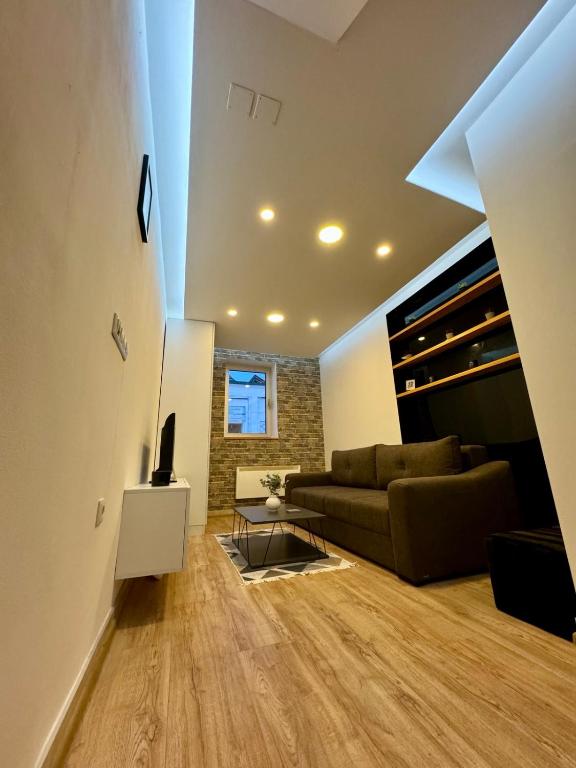 a living room with a couch and a table at Apartment Oscar in Sarajevo