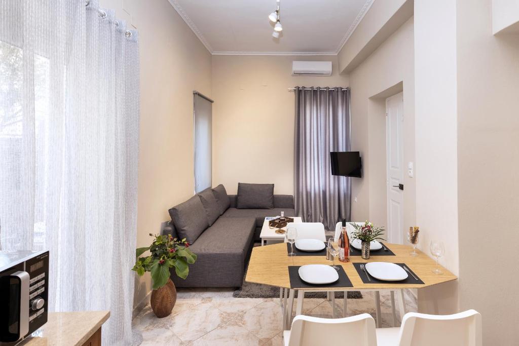 a living room with a couch and a table at Loukoumi in Ermoupoli