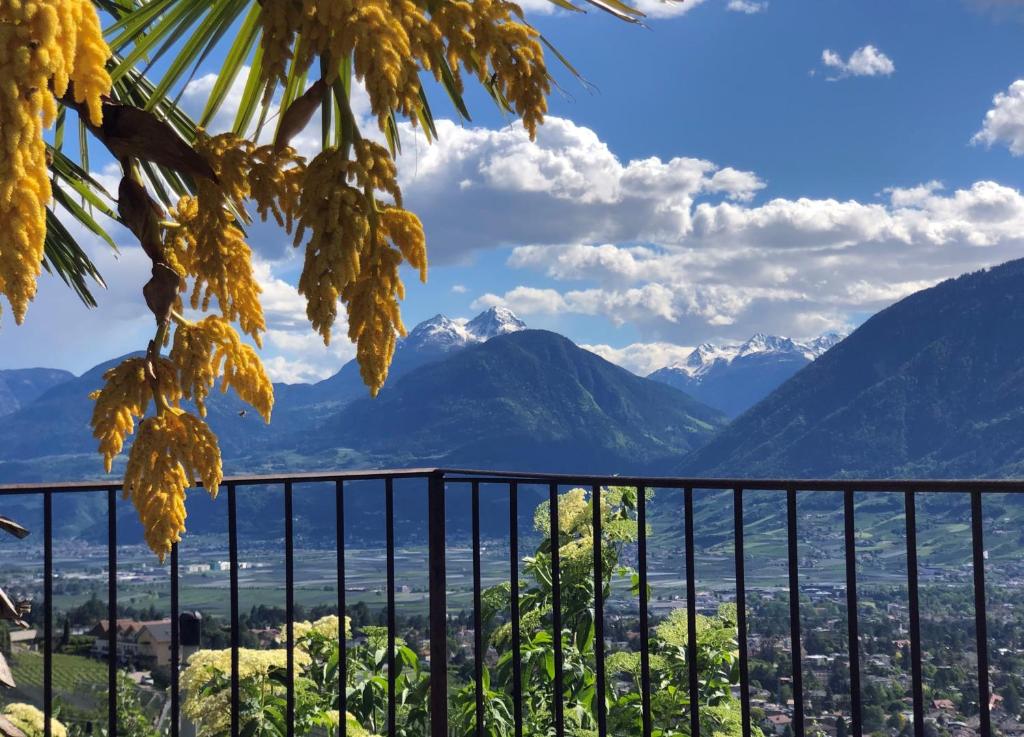 a view of mountains and a city from a balcony at Der Blaue Reiter in Schenna