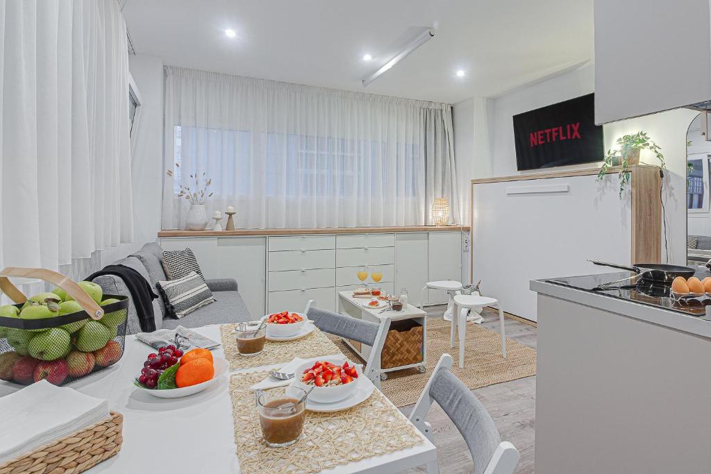 a kitchen with a table with fruit on it at Super Centro y Playa by TheBlueWaveApartments com in A Coruña