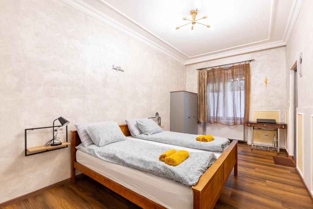 a bedroom with a bed with two yellow pillows at Mari&Emi flat in Corvin in Budapest