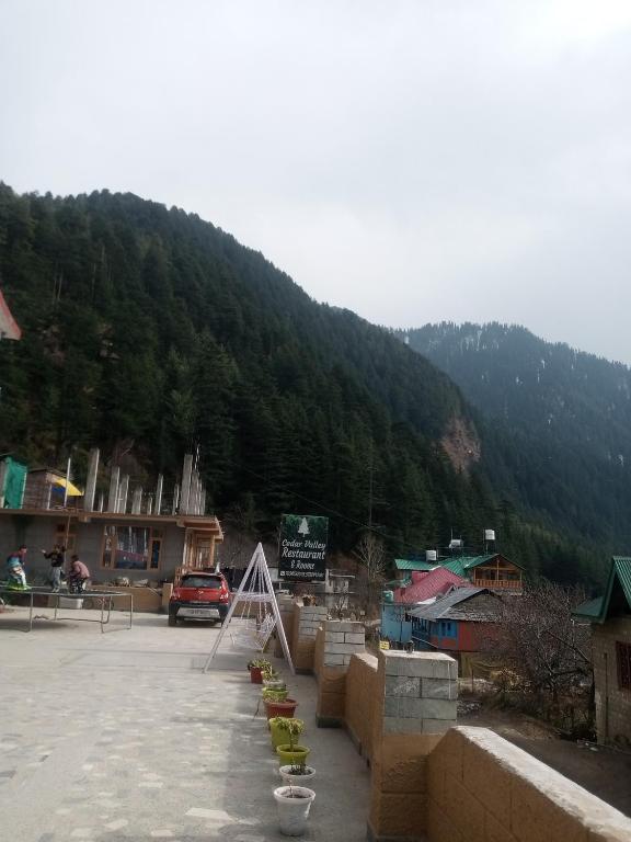 a parking lot in front of a mountain at Anand -Giri Retreat in Nagar