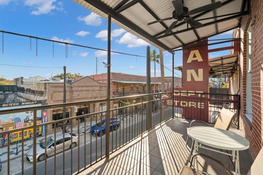 a balcony with a table and a view of a street at NEW! Sangria Suite - Upscale Ybor City Studio, Right On 7th Ave in Tampa