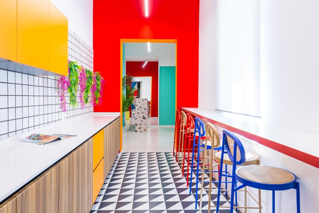 a colorful kitchen with colorful walls and stools at Januarius Domus in Naples