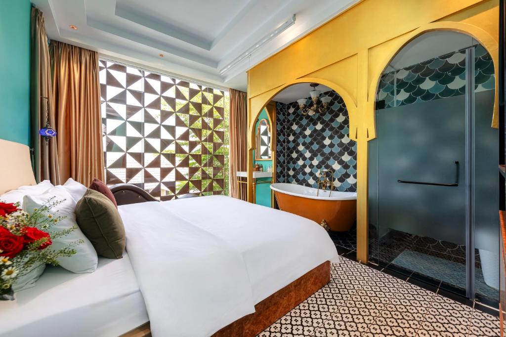 - une chambre avec un lit et une baignoire dans l'établissement Secret Garden Hotel, à Hô-Chi-Minh-Ville