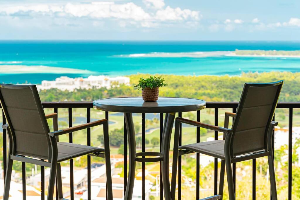 a table with two chairs and a potted plant on a balcony at Trocean View, Amazing Ocean View in Rio Grande
