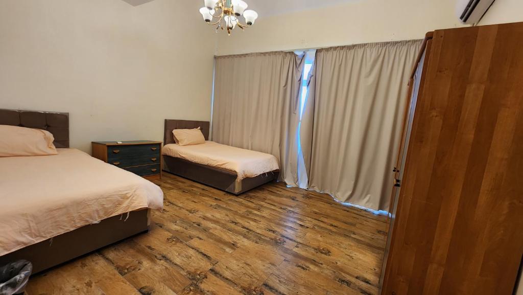 um quarto com 2 camas e uma janela em فيلا بمسبح خاص و شاطئ رملي في درة العروس em Durat Alarous