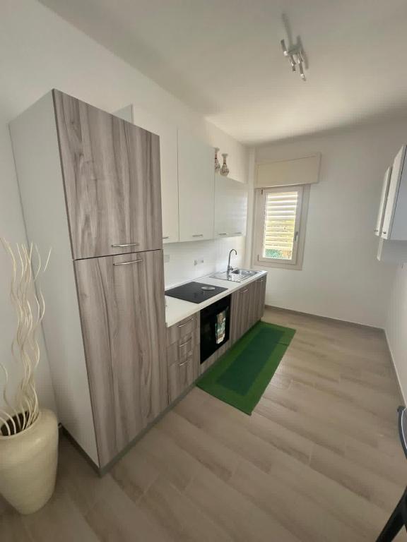 a kitchen with a refrigerator and a sink in it at Casa Valeria in Taranto