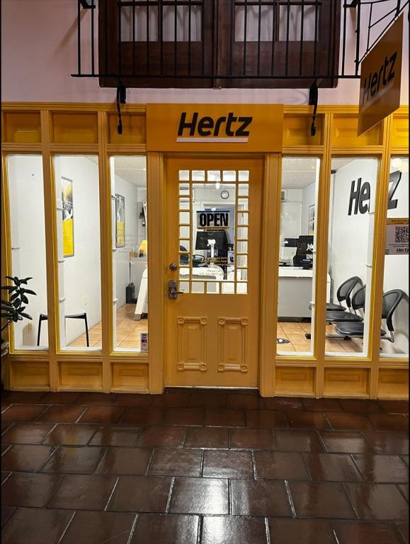 a store front with a herzz sign on the door at Ramada by Wyndham Las Cruces Hotel & Conference Center in Las Cruces