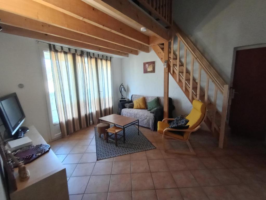 sala de estar con sofá y mesa en Maison de village, en Mollans-sur-Ouvèze