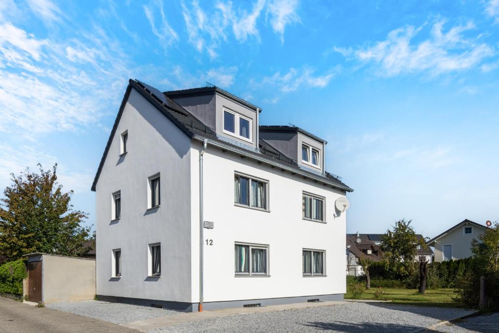 a white house with a black roof at WG-Haus in Landshut