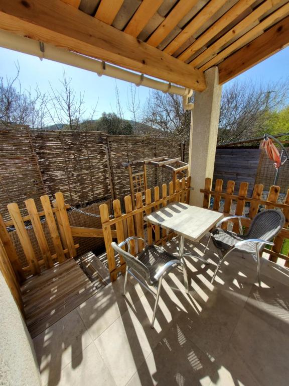 eine Terrasse mit einem Tisch und Stühlen auf einer Terrasse in der Unterkunft La casa Elisa Gîte T2 indépendant in Gréoux-les-Bains