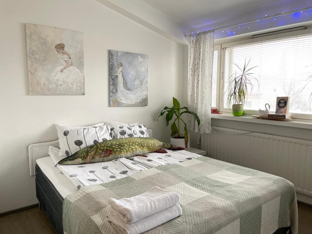 a bedroom with a bed with towels on it at VesiLahti RoofLevel Apartment in Lahti
