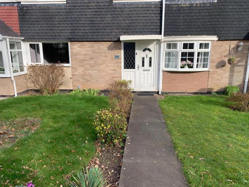 a house with a white door and a grass yard at Impeccable 3-Bed House in Birmingham in Birmingham