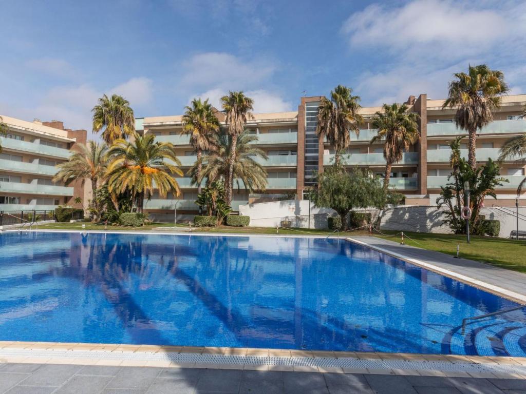 a large swimming pool in front of a building at Apartment Aquaria-1 by Interhome in Salou