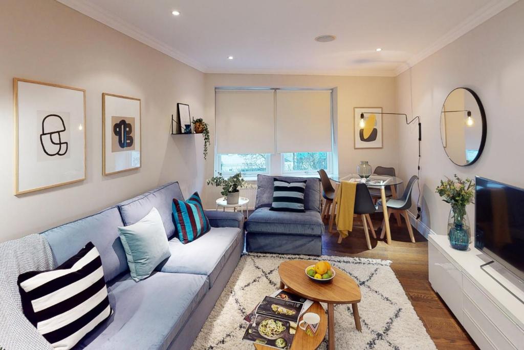 a living room with a couch and a table at Madison Hill - White Hill House 3 - 1 bedroom flat in London