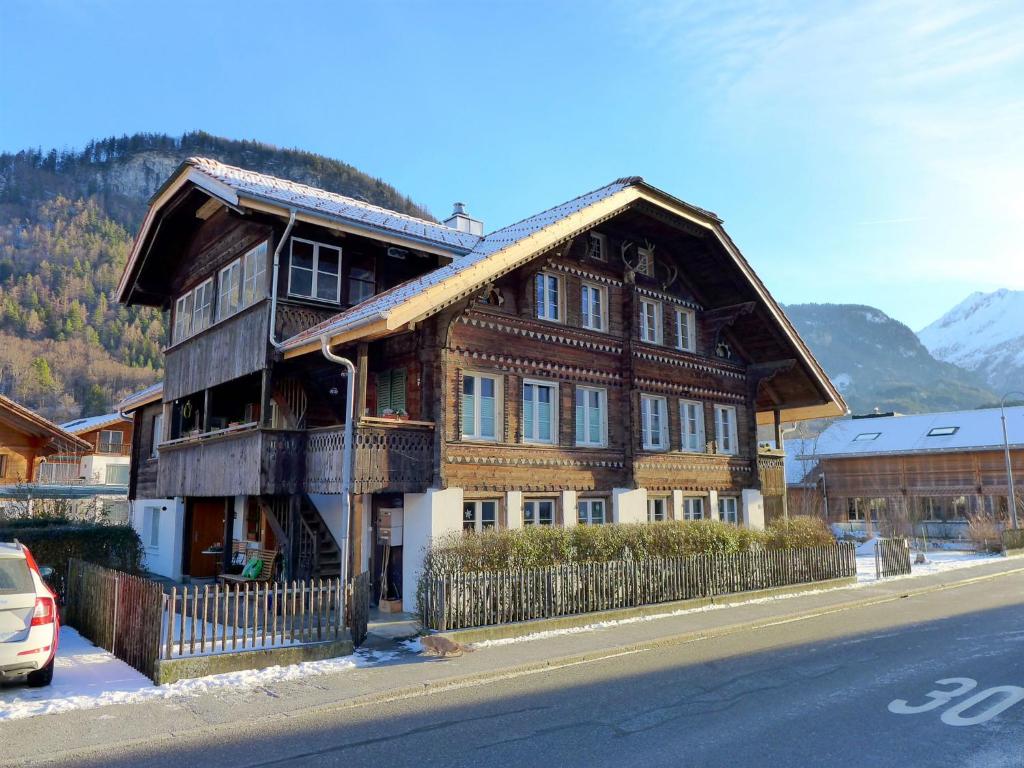 a large wooden house on the side of a street at Apartment Wellhorn by Interhome in Meiringen