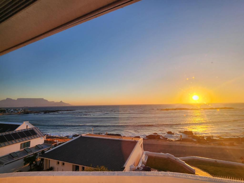 a sunset from the balcony of a condo at The Blue Peter Hotel in Cape Town