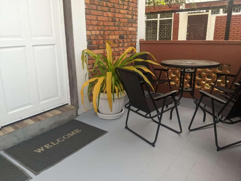 a patio with a table and chairs next to a door at Destination Hope in Georgetown