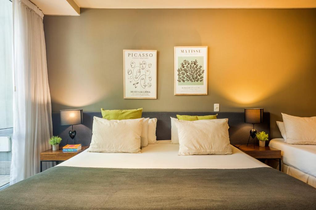 a bedroom with a large bed with two pillows at Premium Studio in heart of Palermo Soho -T107- in Buenos Aires