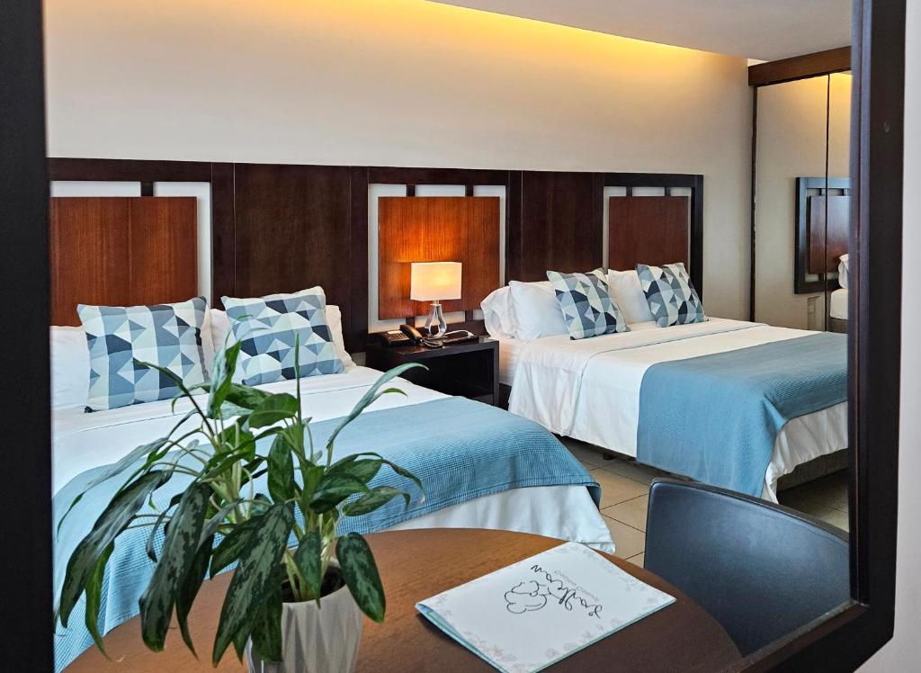 Postel nebo postele na pokoji v ubytování Hotel Perla Spondylus