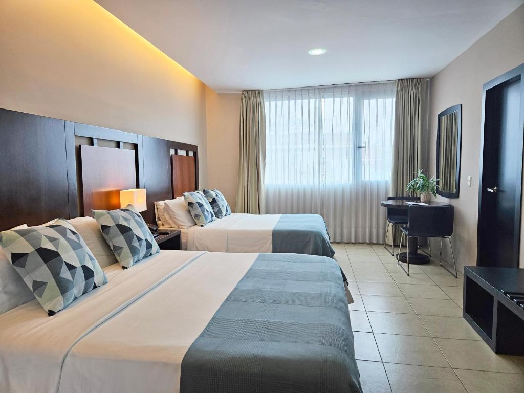Postel nebo postele na pokoji v ubytování Hotel Perla Spondylus