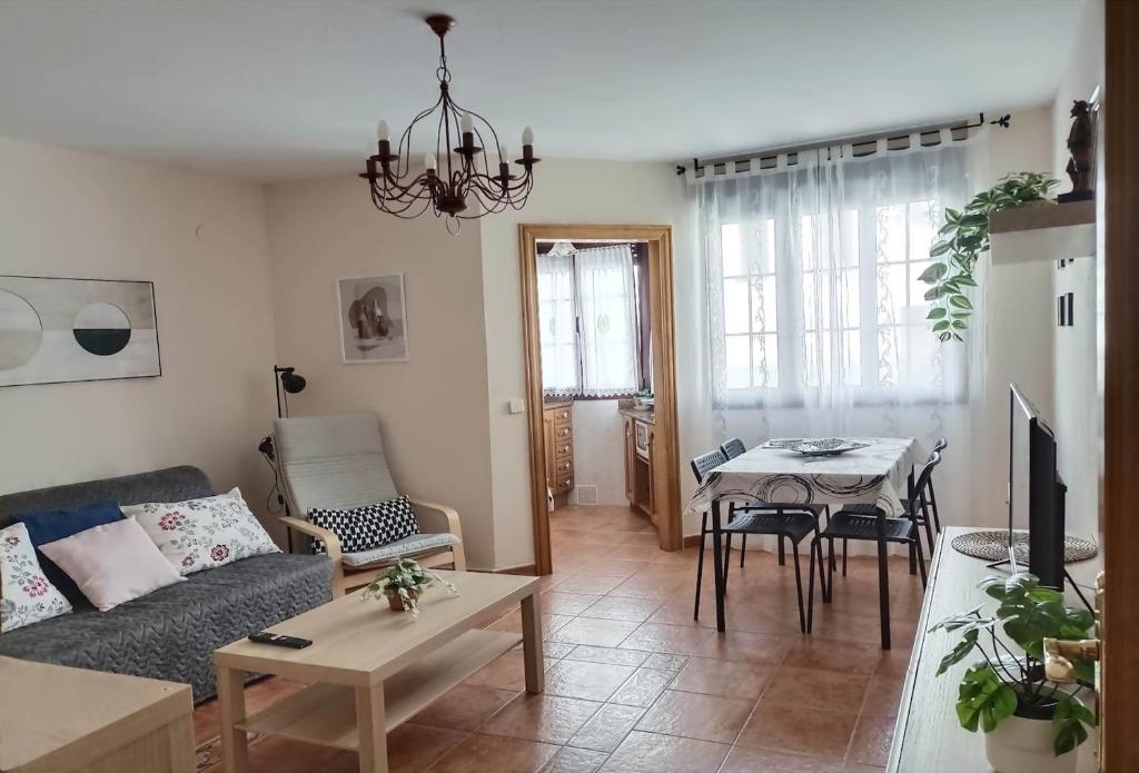 a living room with a couch and a table at Apartamento ideal en Lastres. in Colunga