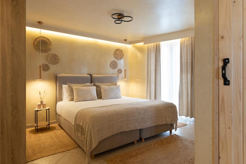 a bedroom with a large bed and a window at Athens Top Penthouse With Spa 5' to Metro in Athens