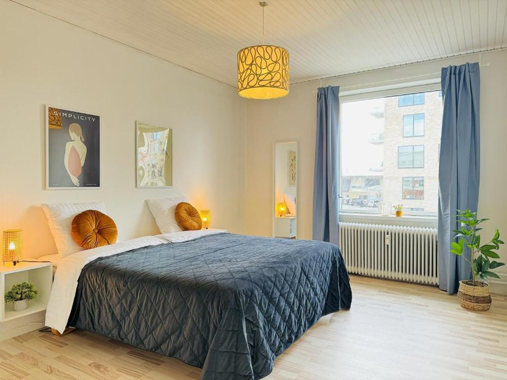 a bedroom with a bed and a large window at aday - 4 bedrooms holiday apartment in Bronderslev in Brønderslev