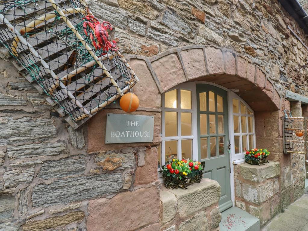 a stone building with a sign that reads the rotunda at The Boathouse Seahouses in Seahouses
