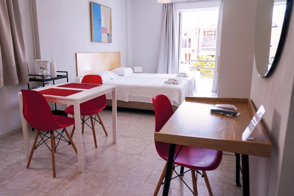 a room with a bed and a table and chairs at Dimitris City Break Apts in Chania Town