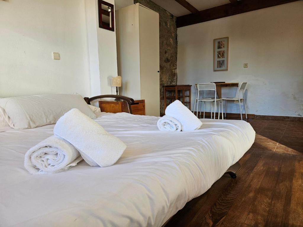 a bedroom with a white bed with towels on it at 17A01 -Apartamento Caravia in Caravia
