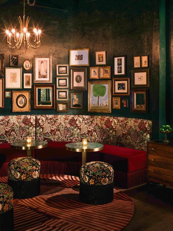 a room with a couch and pictures on the wall at Beacon Grand, A Union Square Hotel in San Francisco