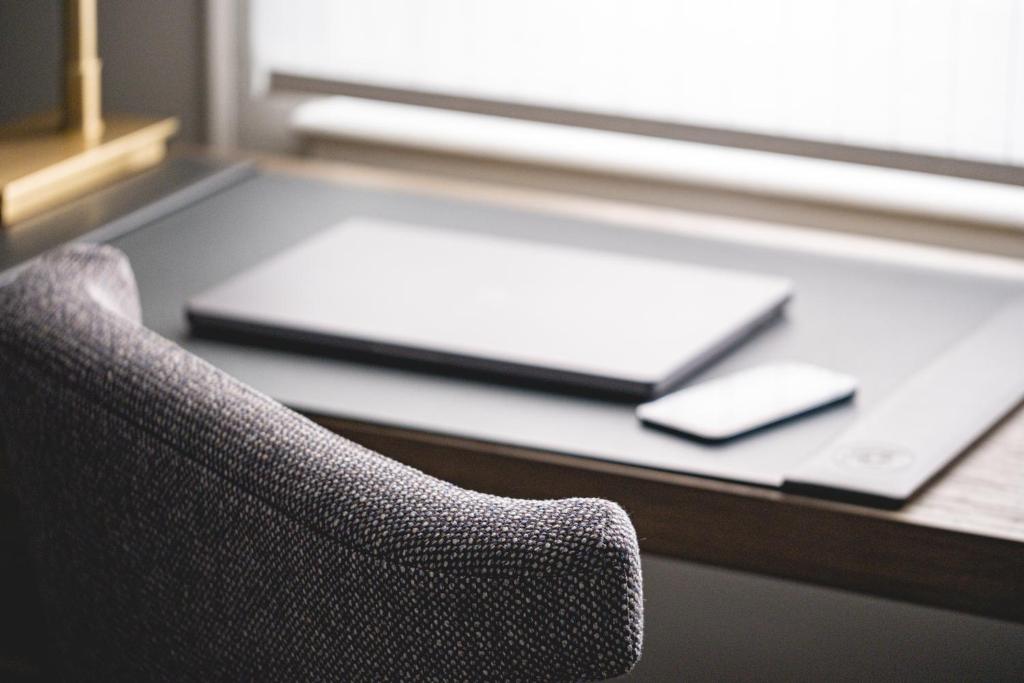 a chair in front of a desk with a laptop at Beacon Grand, A Union Square Hotel in San Francisco