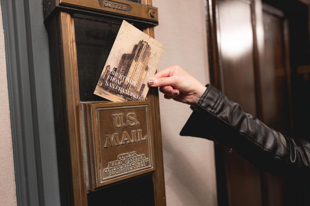a person is putting a us army card on a us army clock at Beacon Grand, A Union Square Hotel in San Francisco