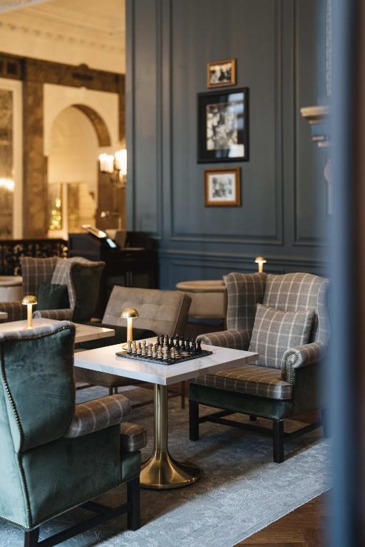 a living room filled with furniture and a chessboard on a table at Beacon Grand, A Union Square Hotel in San Francisco