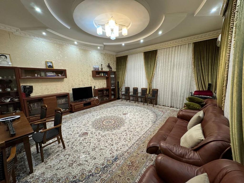 a large living room with a couch and a television at Bray Relax Home in Farsala