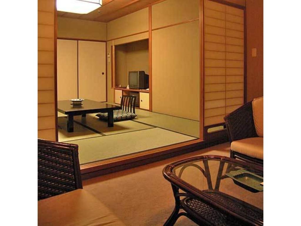 a living room with a table and a television at Kotobukirou - Vacation STAY 01907v in Kobe